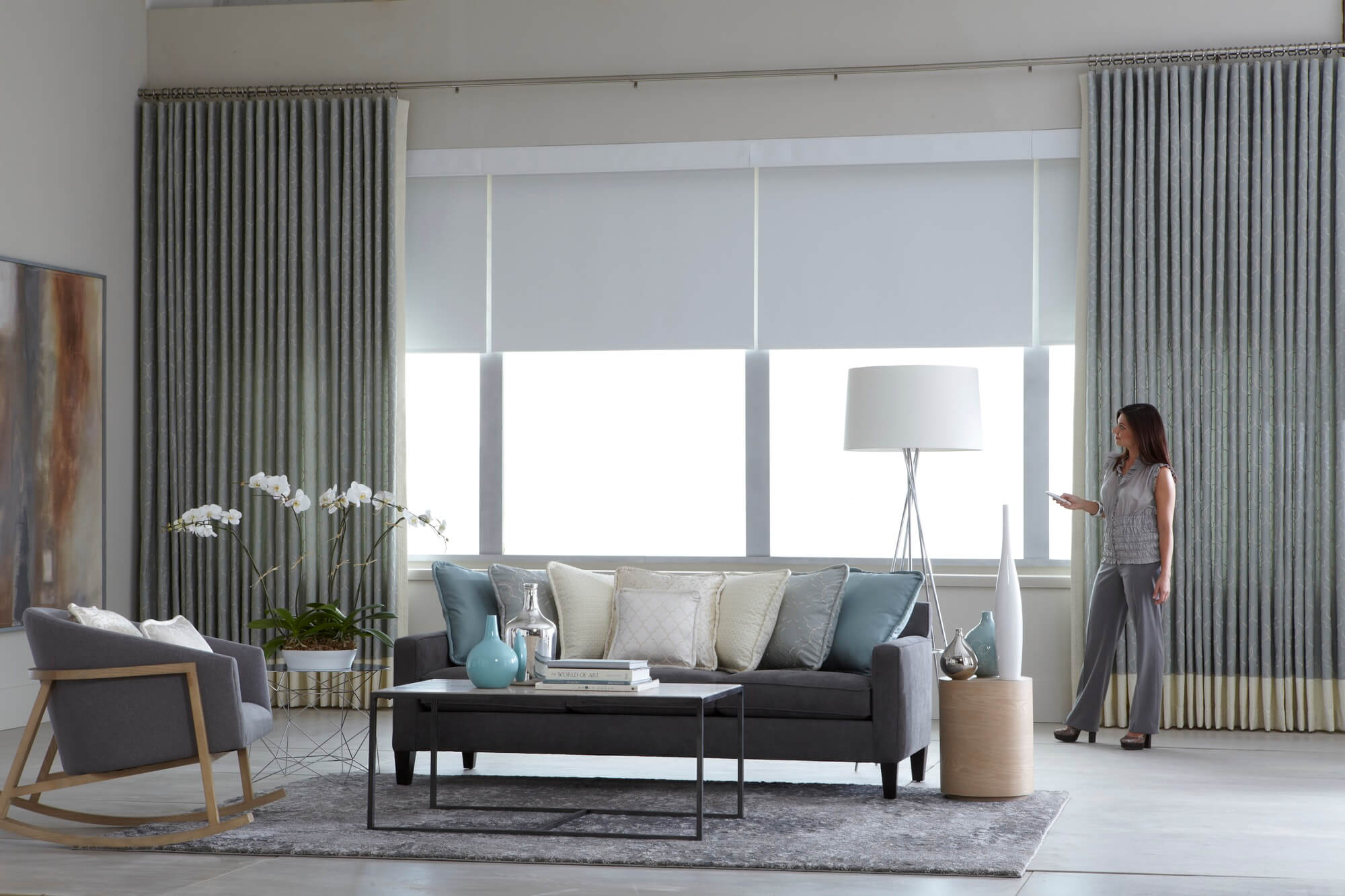 Elegant living room with motorized roller shades and drapes
